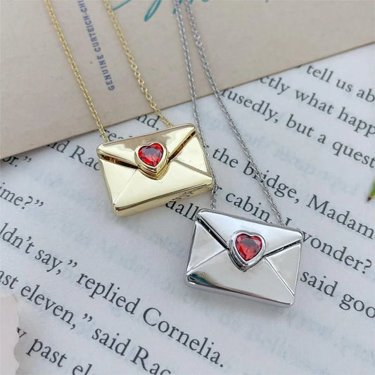 A copper envelope necklace inlaid with red hearts